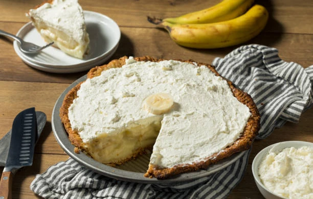 A banana cream pie with whipped cream