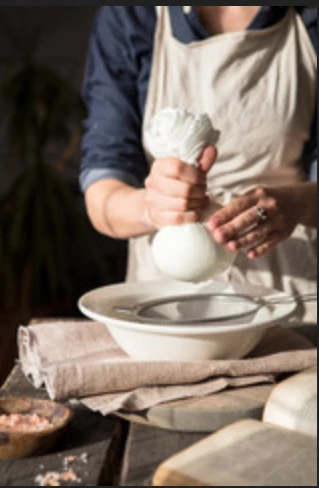 Traditional Greek yogurt straining in cheesecloth