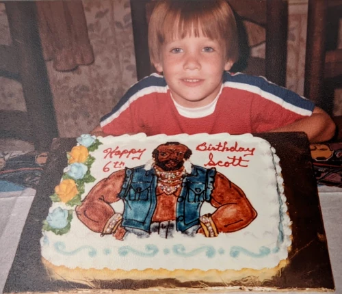 A Mr. T birthday cake and a happy child